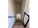 Carpeted staircase leading to upper or lower levels of the home with black handrails at 2295 Golden Valley Dr, Lawrenceville, GA 30043