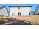View of the home's rear exterior and backyard with a door leading to a patio area at 3557 Bryant Meadow Cir, Buford, GA 30519