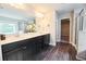 Modern bathroom featuring double vanity with dark cabinets, and a large mirror with plenty of lighting at 3557 Bryant Meadow Cir, Buford, GA 30519