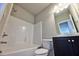 Clean bathroom featuring a shower-tub combination, dark vanity, and well-lit mirror at 3557 Bryant Meadow Cir, Buford, GA 30519