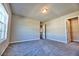 Spacious bedroom with plush carpeting, natural light, and a convenient walk-in closet at 3557 Bryant Meadow Cir, Buford, GA 30519