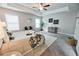 Spacious main bedroom with tray ceilings, carpeted floor, a sitting area, and natural lighting at 3557 Bryant Meadow Cir, Buford, GA 30519