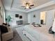 Spacious main bedroom with tray ceiling, ensuite access, and ample natural light creating a serene space at 3557 Bryant Meadow Cir, Buford, GA 30519