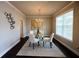 Bright dining room with a glass table, comfortable seating, and a contemporary chandelier at 3557 Bryant Meadow Cir, Buford, GA 30519