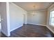 Elegant dining room featuring hardwood floors, crown molding, and a decorative chandelier at 3557 Bryant Meadow Cir, Buford, GA 30519