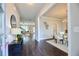 Inviting entryway with dark wood floors, console table, and views into the dining and living areas at 3557 Bryant Meadow Cir, Buford, GA 30519