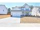 Charming two-story home featuring a welcoming front porch and attached two-car garage at 3557 Bryant Meadow Cir, Buford, GA 30519