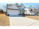 Beautiful home with a spacious driveway leading to an attached two-car garage at 3557 Bryant Meadow Cir, Buford, GA 30519