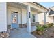 Inviting front porch with classic columns and stylish front door, enhancing curb appeal at 3557 Bryant Meadow Cir, Buford, GA 30519