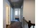 Upstairs carpeted hallway with neutral walls leads to bedrooms and bathrooms at 3557 Bryant Meadow Cir, Buford, GA 30519