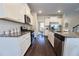 Modern kitchen with granite countertops, stainless steel appliances, and a seamless flow into the dining area at 3557 Bryant Meadow Cir, Buford, GA 30519