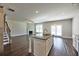 Spacious living area with a kitchen island, fireplace, and access to the outdoors at 3557 Bryant Meadow Cir, Buford, GA 30519