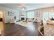 Open concept living room featuring hardwood floors, a fireplace, and modern furnishings at 3557 Bryant Meadow Cir, Buford, GA 30519