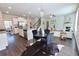 Beautiful living space offers an open concept with a dining area, kitchen, and cozy fireplace at 3557 Bryant Meadow Cir, Buford, GA 30519
