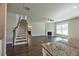 Open concept living space featuring a fireplace, stairs, and granite countertop detail at 3557 Bryant Meadow Cir, Buford, GA 30519