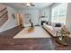 Cozy living room with a fireplace, neutral furniture, and a large window for natural light at 3557 Bryant Meadow Cir, Buford, GA 30519