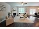 Open living space with fireplace, large windows, and hardwood floors creating a bright atmosphere at 3557 Bryant Meadow Cir, Buford, GA 30519
