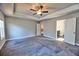 Inviting main bedroom with a tray ceiling, a ceiling fan, and an en-suite bathroom at 3557 Bryant Meadow Cir, Buford, GA 30519