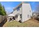 Exterior view of home with fenced yard and patio area perfect for outdoor entertaining at 4084 Elsdon Dr, Austell, GA 30106