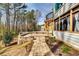 Inviting backyard with a stone walkway, tiered patio, lush landscaping, and a tranquil wooded view at 6921 Springbank Way, Stone Mountain, GA 30087