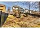 Spacious backyard featuring a wooden deck, walkout sunroom, patio, and manicured landscaping enclosed with a fence at 6921 Springbank Way, Stone Mountain, GA 30087