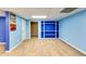 Finished basement featuring blue walls, neutral carpeting, and built-in shelving at 6921 Springbank Way, Stone Mountain, GA 30087