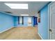 Finished basement featuring blue walls, neutral carpeting, and natural light at 6921 Springbank Way, Stone Mountain, GA 30087