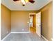 Carpeted bedroom with neutral walls and a standard ceiling fan with lighting at 6921 Springbank Way, Stone Mountain, GA 30087