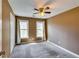 Carpeted bedroom with two windows, neutral walls, and a standard ceiling fan with lighting at 6921 Springbank Way, Stone Mountain, GA 30087
