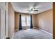 Carpeted bedroom with one window, neutral walls, and curtains for added style at 6921 Springbank Way, Stone Mountain, GA 30087