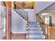 Elegant foyer featuring hardwood floors, staircase with iron spindles, and soaring ceilings at 6921 Springbank Way, Stone Mountain, GA 30087