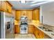 Well-lit kitchen featuring stainless steel appliances, granite countertops, and tiled backsplash at 6921 Springbank Way, Stone Mountain, GA 30087