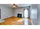 Cozy living room with hardwood floors, fireplace, and natural light streaming through a large window at 6921 Springbank Way, Stone Mountain, GA 30087