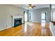 Cozy living room with hardwood floors, fireplace, and natural light streaming through a large window at 6921 Springbank Way, Stone Mountain, GA 30087