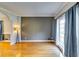 Bright living room with hardwood floors, large window with curtains, and neutral color scheme at 6921 Springbank Way, Stone Mountain, GA 30087