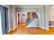 Open-concept living room with hardwood floors, staircase, and neutral paint colors at 6921 Springbank Way, Stone Mountain, GA 30087