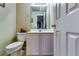 Simple powder room with neutral walls, single sink vanity, decorative accents, and a view to an adjacent space at 6921 Springbank Way, Stone Mountain, GA 30087