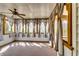 Cozy sunroom featuring natural lighting, a ceiling fan, neutral carpet, and multiple curtained windows at 6921 Springbank Way, Stone Mountain, GA 30087