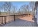 Spacious back deck with wooden railings offering serene views of the surrounding landscape at 7985 Thunder River Way, Cumming, GA 30028