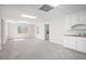 Large room with neutral carpet and a wet bar on the far right side of the image at 7985 Thunder River Way, Cumming, GA 30028