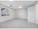 Spacious, carpeted basement room with ample natural light from the window at 7985 Thunder River Way, Cumming, GA 30028