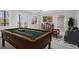 Finished basement featuring a billiards table, wet bar, and sitting area with neutral carpeting at 7985 Thunder River Way, Cumming, GA 30028