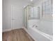 Well-appointed bathroom features a soaking tub, shower, and wood-look flooring at 7985 Thunder River Way, Cumming, GA 30028