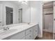 Bathroom featuring double sink vanity with granite countertops and a glass shower at 7985 Thunder River Way, Cumming, GA 30028