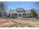 Charming single-Gathering home featuring a welcoming front porch and black wrought iron fence at 7985 Thunder River Way, Cumming, GA 30028