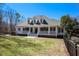 Charming single-Gathering home with a welcoming front porch and manicured lawn at 7985 Thunder River Way, Cumming, GA 30028