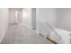 Inviting hallway with neutral carpeting and a staircase leading to the upper level at 7985 Thunder River Way, Cumming, GA 30028