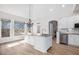 Bright and airy kitchen featuring wood floors and a center island with granite countertops at 7985 Thunder River Way, Cumming, GA 30028