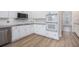 Modern kitchen with white cabinets, granite countertops, stainless steel appliances, and tile backsplash at 7985 Thunder River Way, Cumming, GA 30028