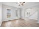 Open concept living room featuring wood floors and views of the entry stairs at 7985 Thunder River Way, Cumming, GA 30028